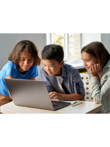 Three children gathered around a laptop computer.